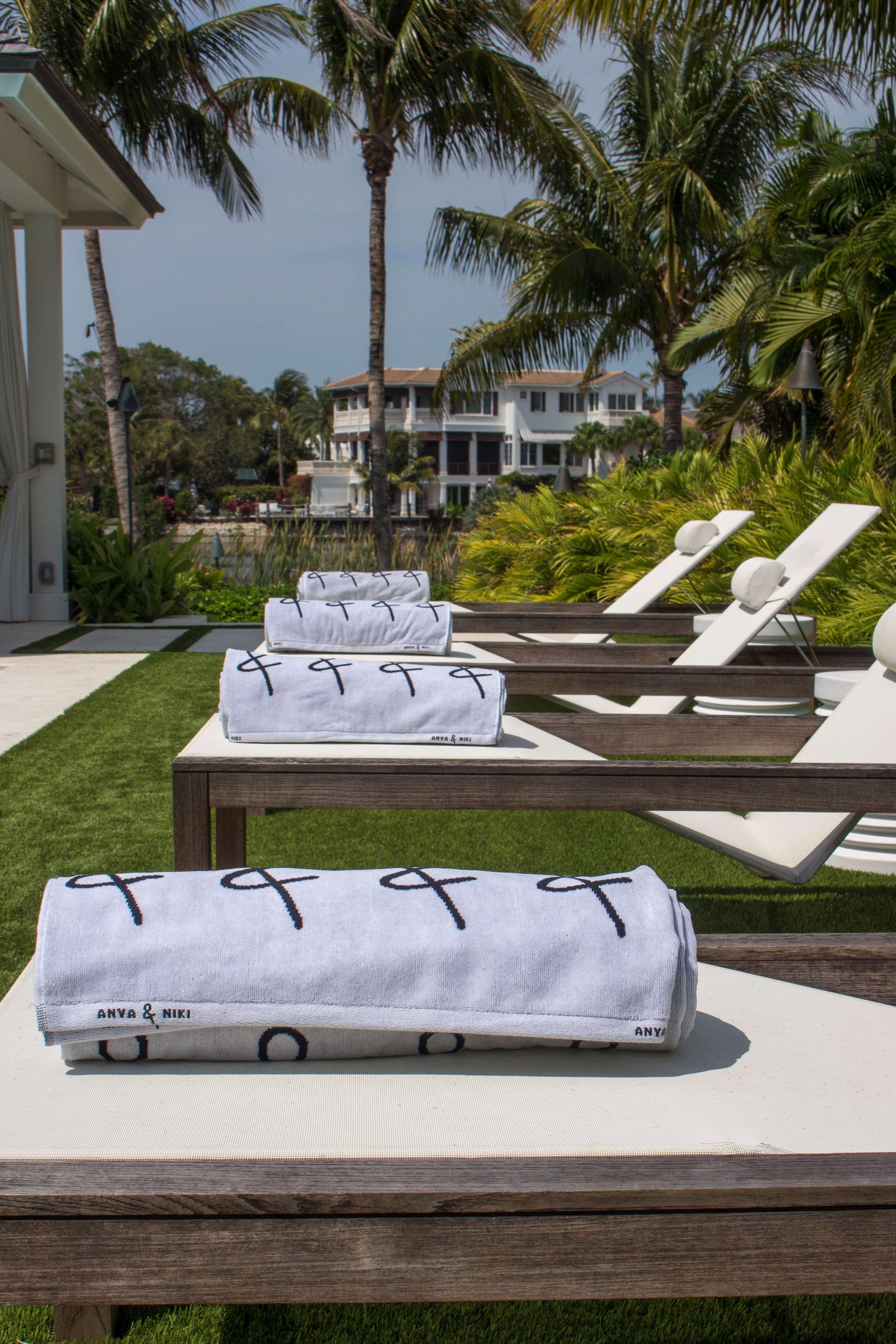 Anya & Niki beach towels on pool chairs