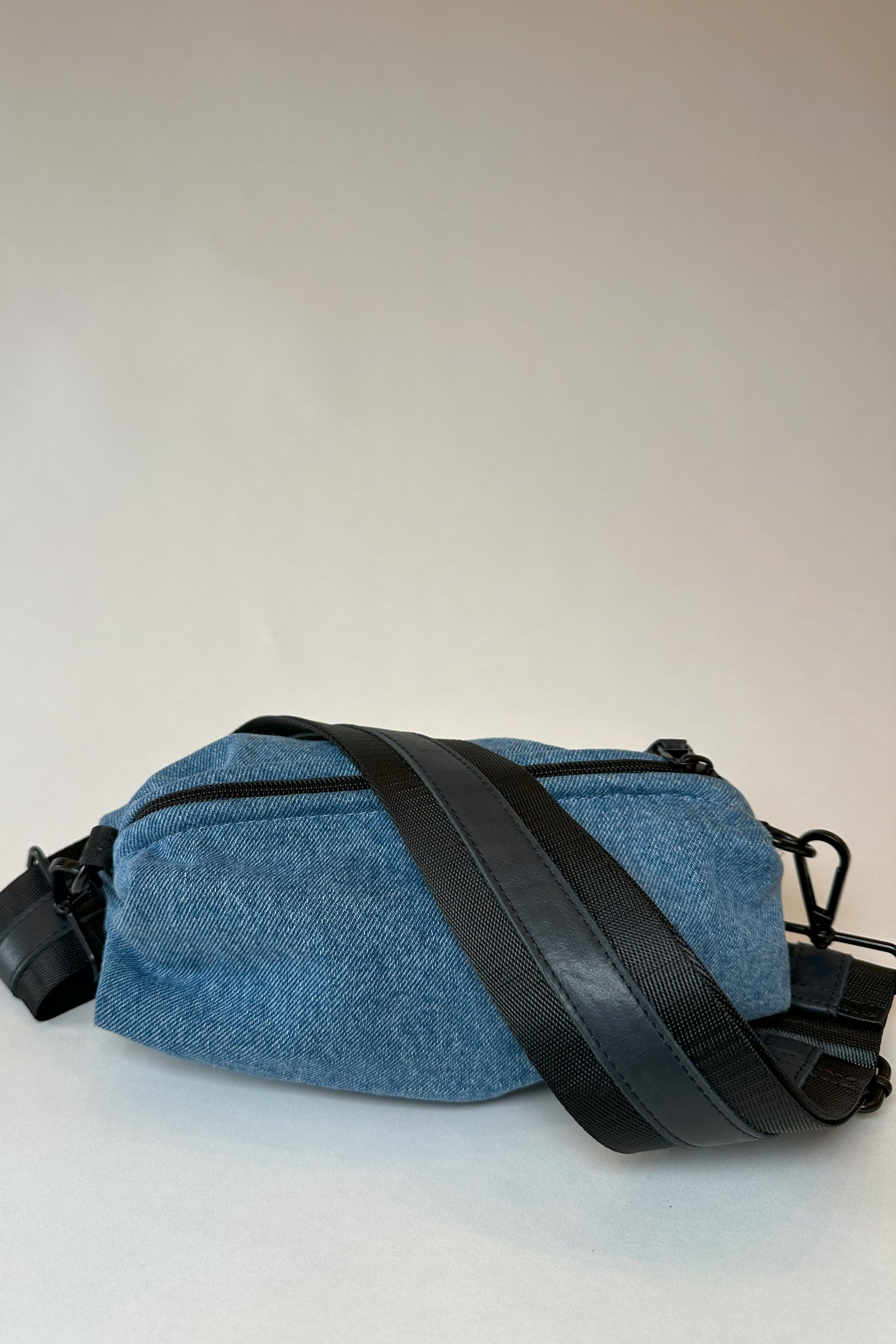 Denim belt bag with black crossbody/belt bag strap with black leather detail