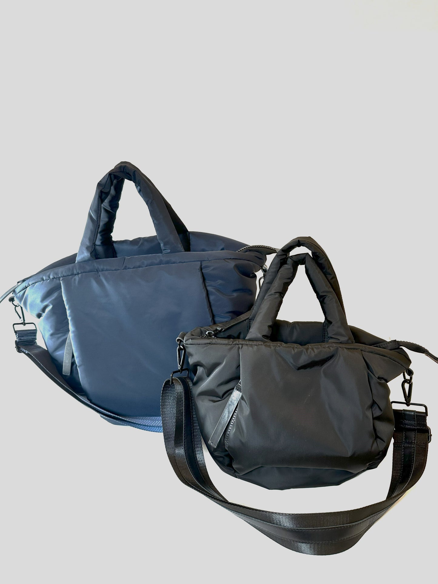 collection of 2 nylon puffy tote bags with crossbody strap: navy large and black medium