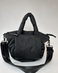 Mid-sized black nylon puffy tote with removable crossbody strap with leather detail