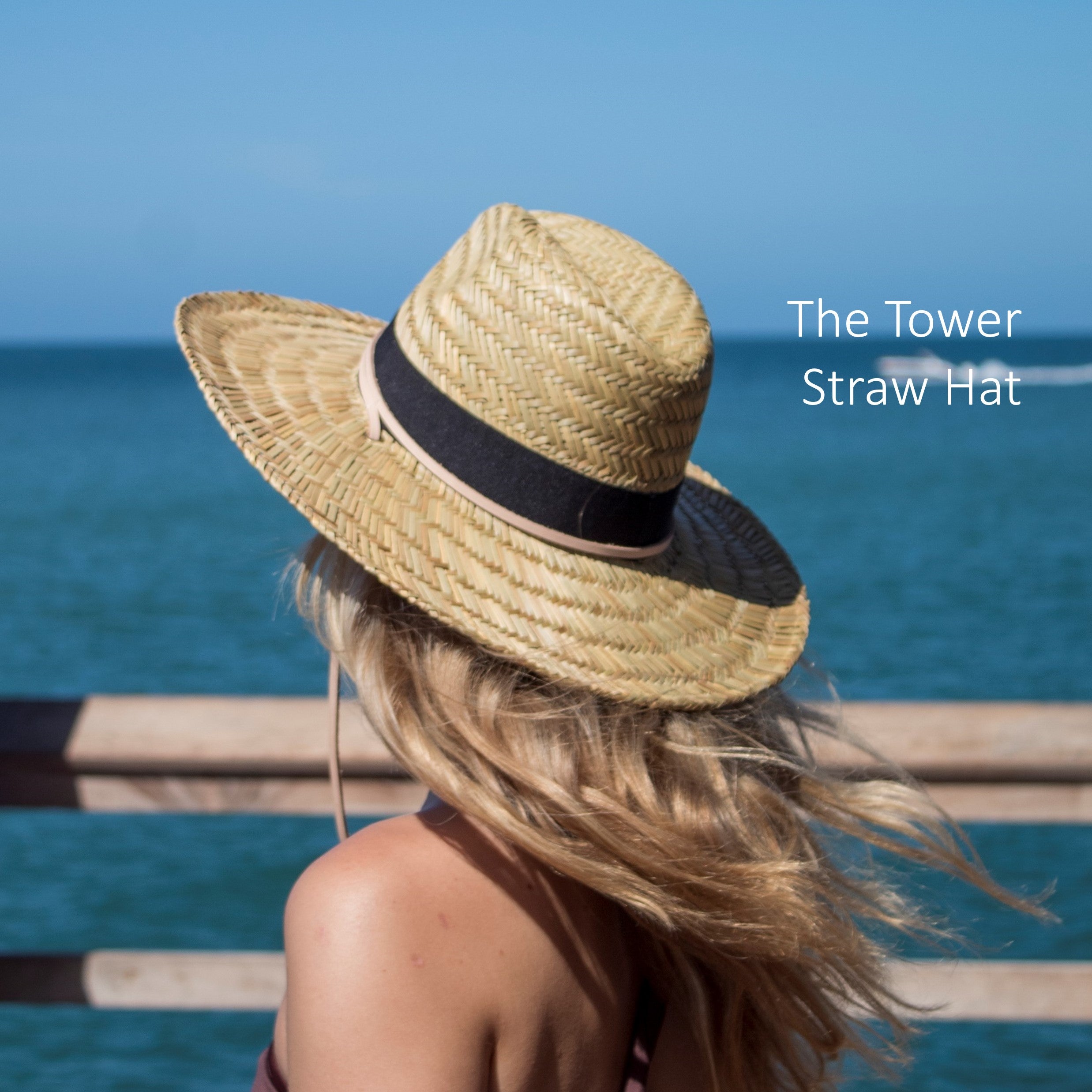 Person at the pier wearing the Straw Tower Lifeguard Hat
