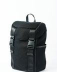 Black mesh backpack with leather details and shiny silver drawstring top.