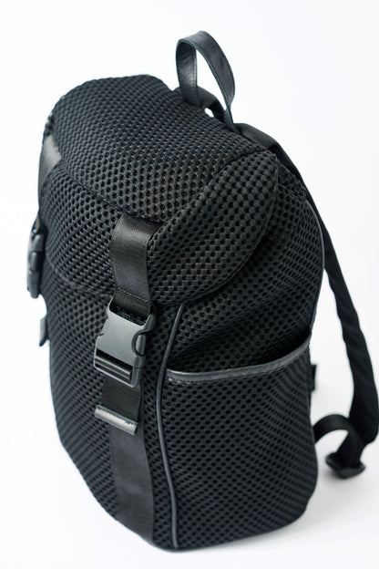 Black mesh backpack with leather details and shiny silver drawstring top.