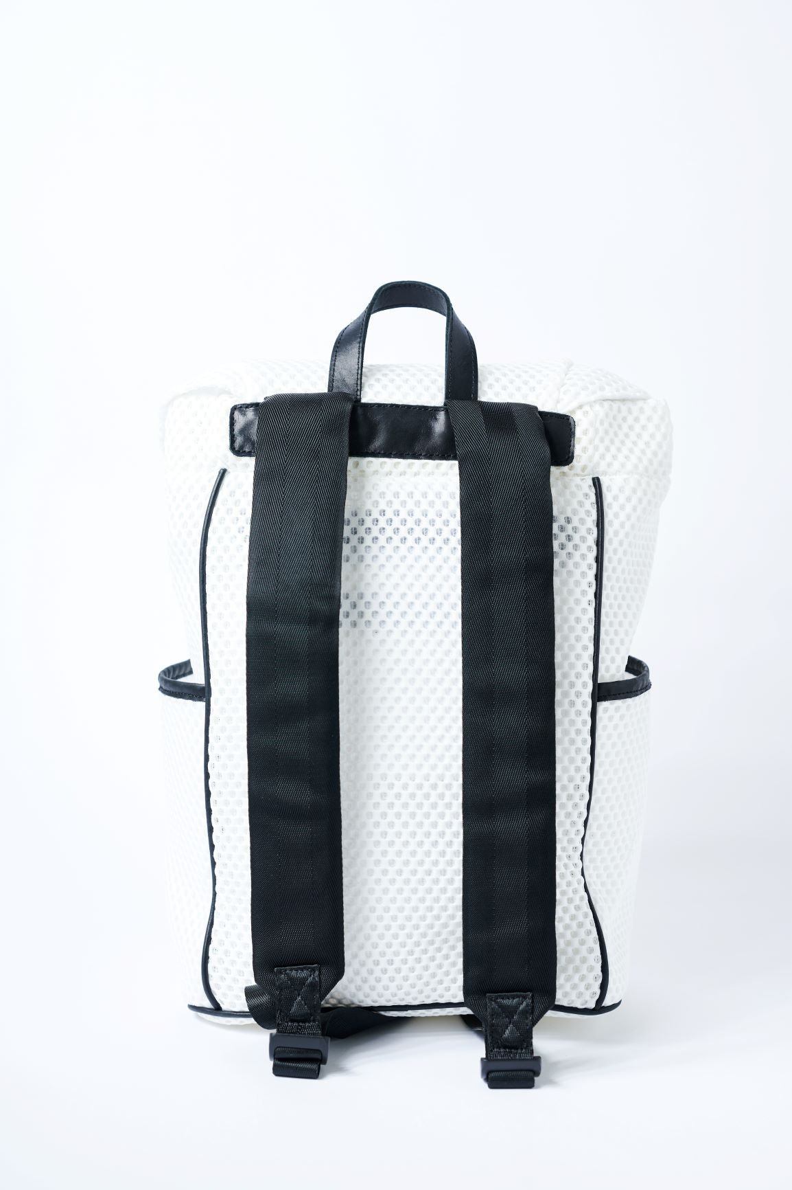 Back view of white mesh backpack with leather details and clear drawstring top.