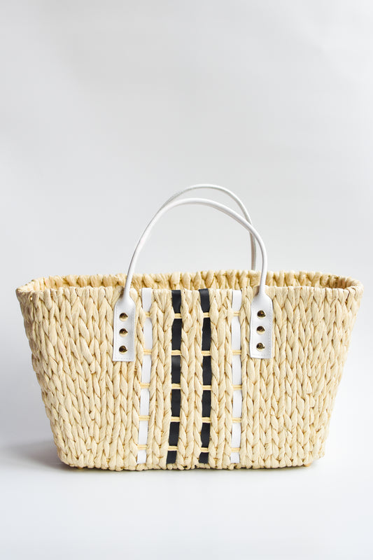 Small woven straw tote bag laced with black and white leather.