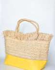 Natural raffia straw tote with linen lining and yellow color block base.