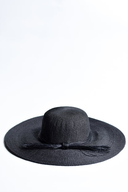 Black floppy straw hat with multi-strand black cording band.
