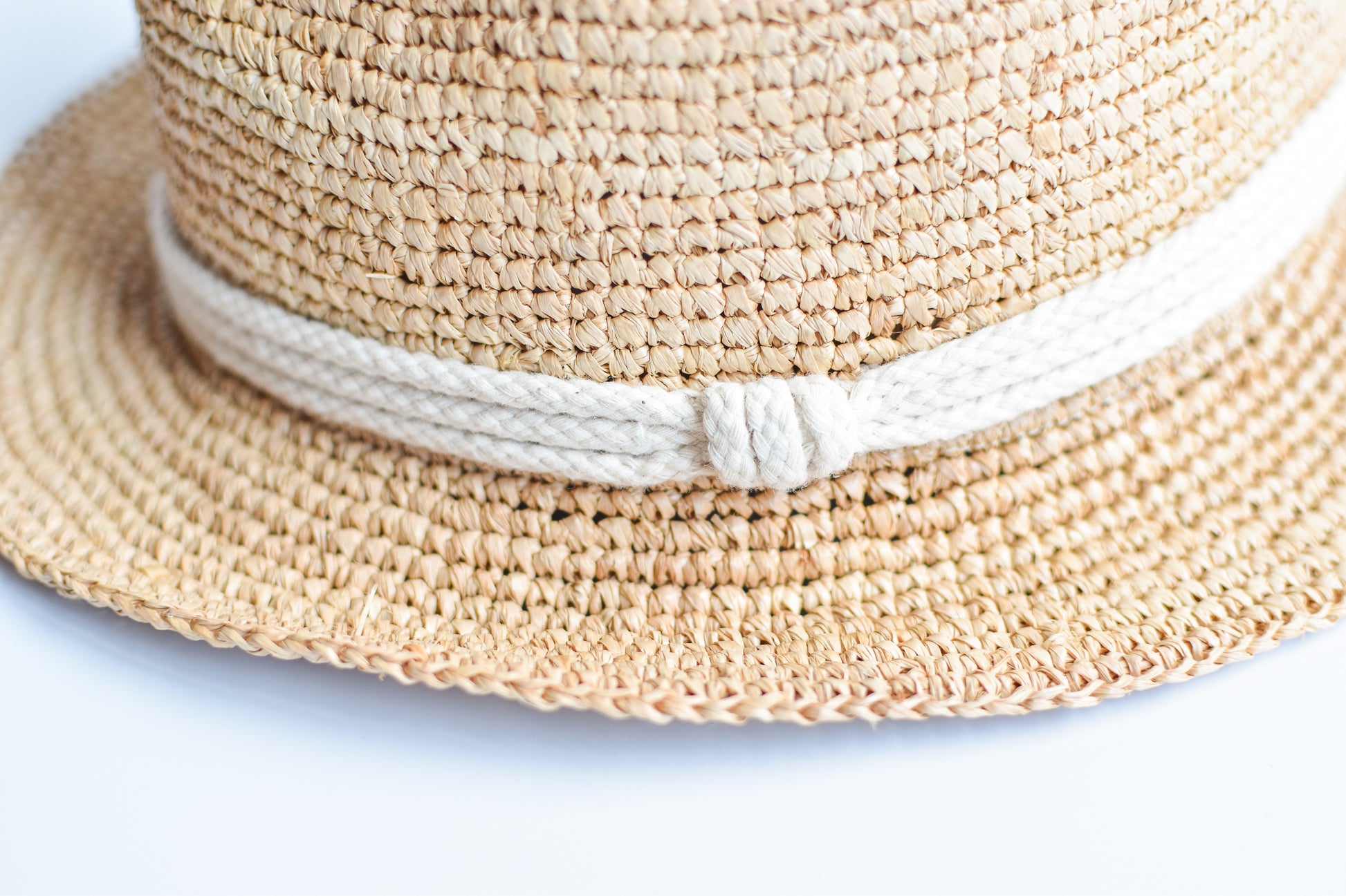 Close up of rope band detail on crochet straw fedora hat.