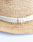 Close up of rope band detail on crochet straw fedora hat.