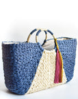 Navy and natural colored over-sized straw tote with circle handle and suede tassels.