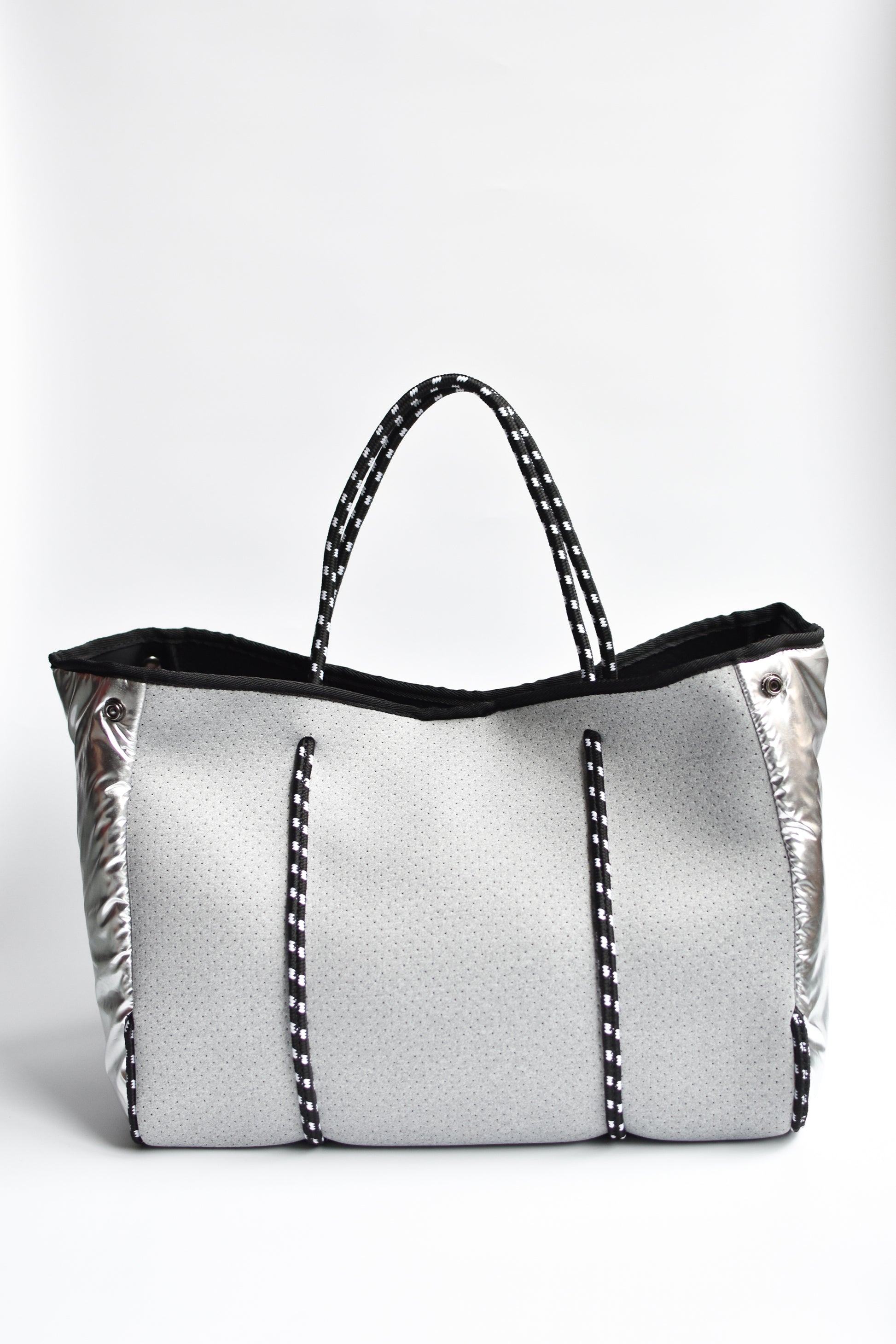 Perforated gray neoprene tote bag with black cord handle and adjustable high shine silver sides.