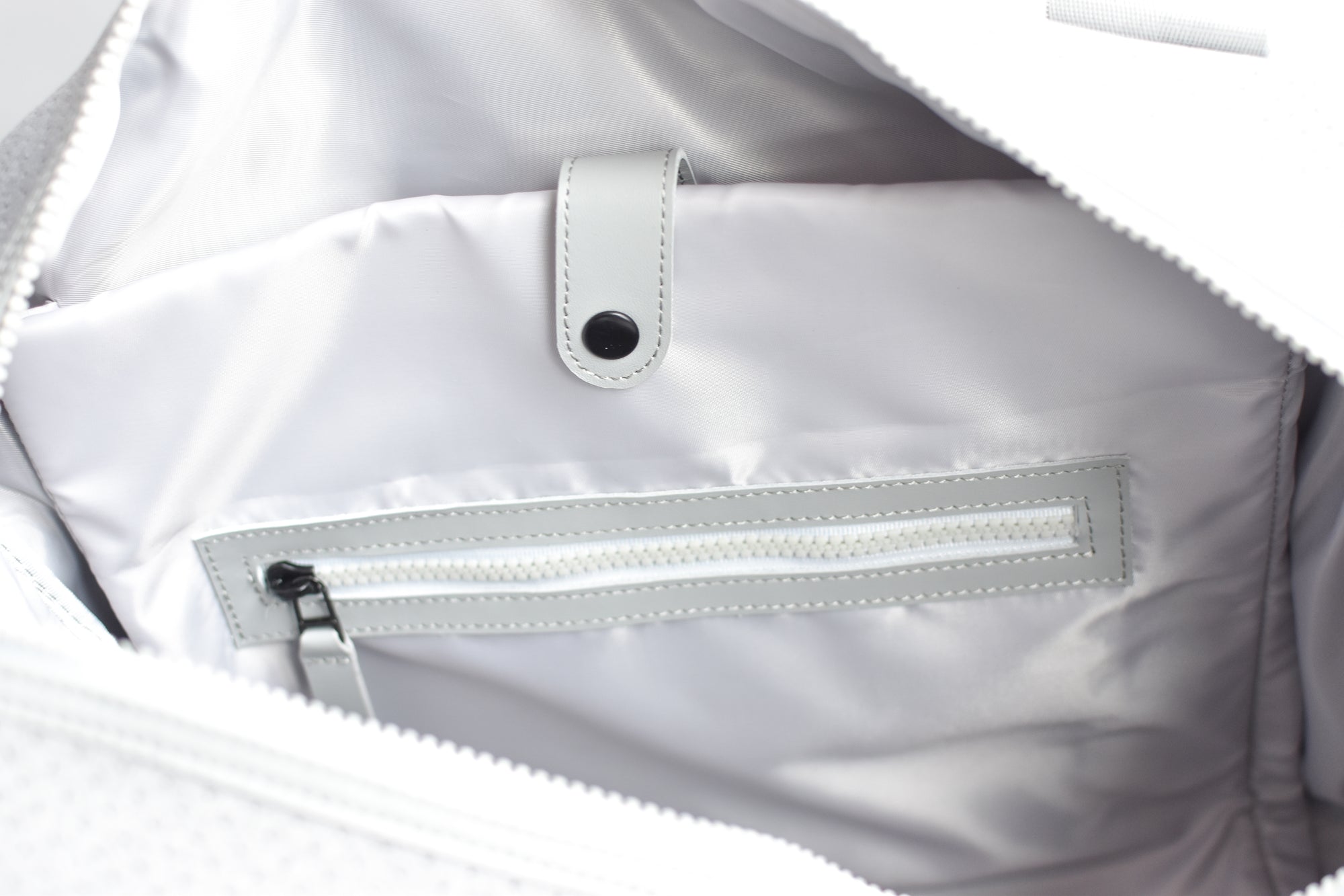 Close up of interior organization on the Callahan grey neoprene duffel bag from Anya &amp; Niki.