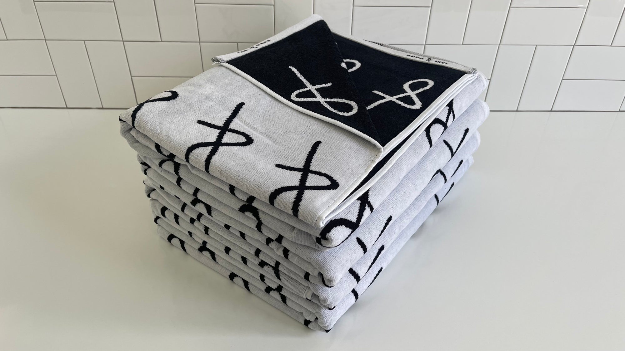 stack of Anya &amp; Niki beach towels 