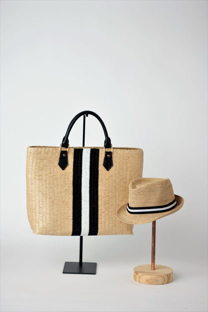 Collection of Anya & Niki Benicia straw tote bag with black leather handles and black & white center stripe, along with the Essential crochet straw hat with black and white band. 