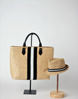 Collection of Anya & Niki Benicia straw tote bag with black leather handles and black & white center stripe, along with the Essential crochet straw hat with black and white band. 