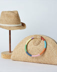 Collection of Anya & Niki Essential crochet straw hat with rope band and the Palma half-moon straw clutch with circle handle.