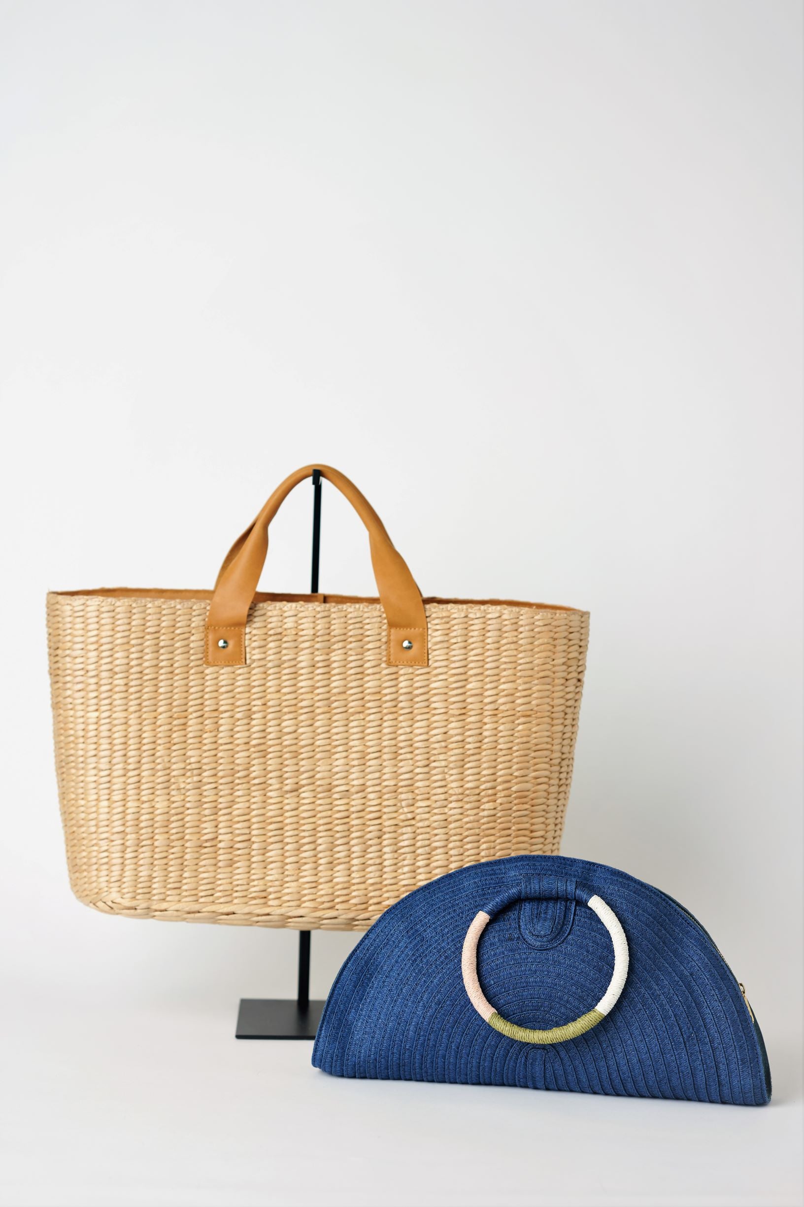Collection of Anya & Niki Westmont straw bag with leather handles and Posey navy straw half moon clutch.