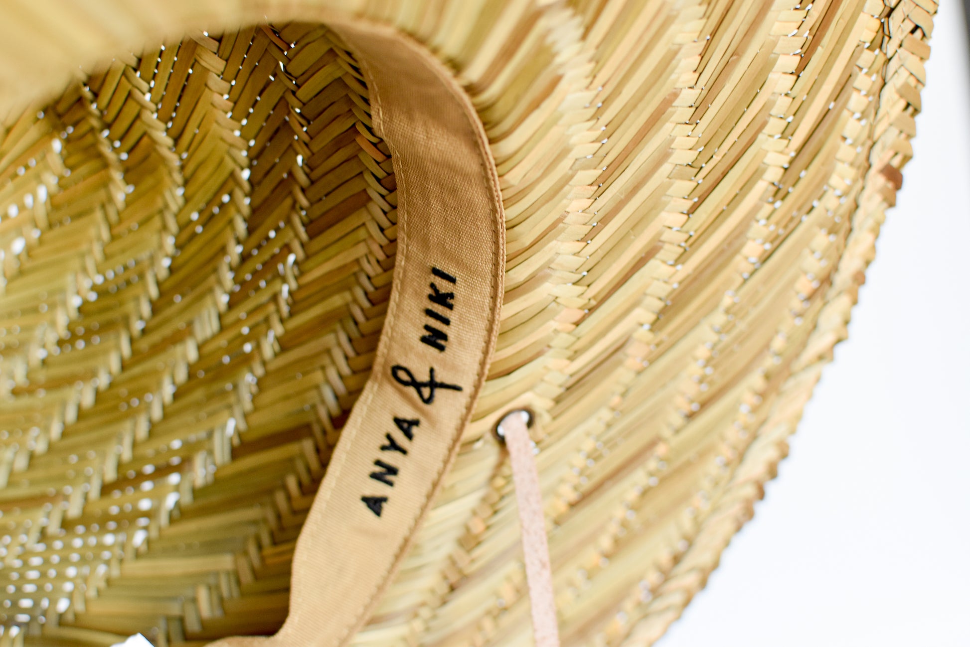 Close up of adjustable interior band on straw lifeguard hat. 