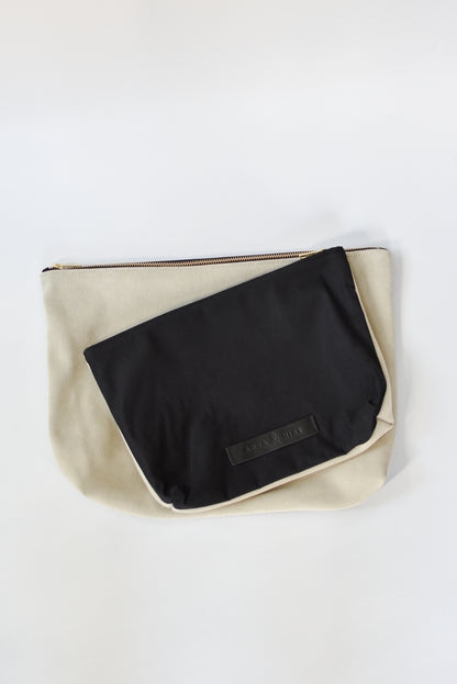 Black cotton canvas and off-white suede medium and large pouch with brass zipper and leather logo label.
