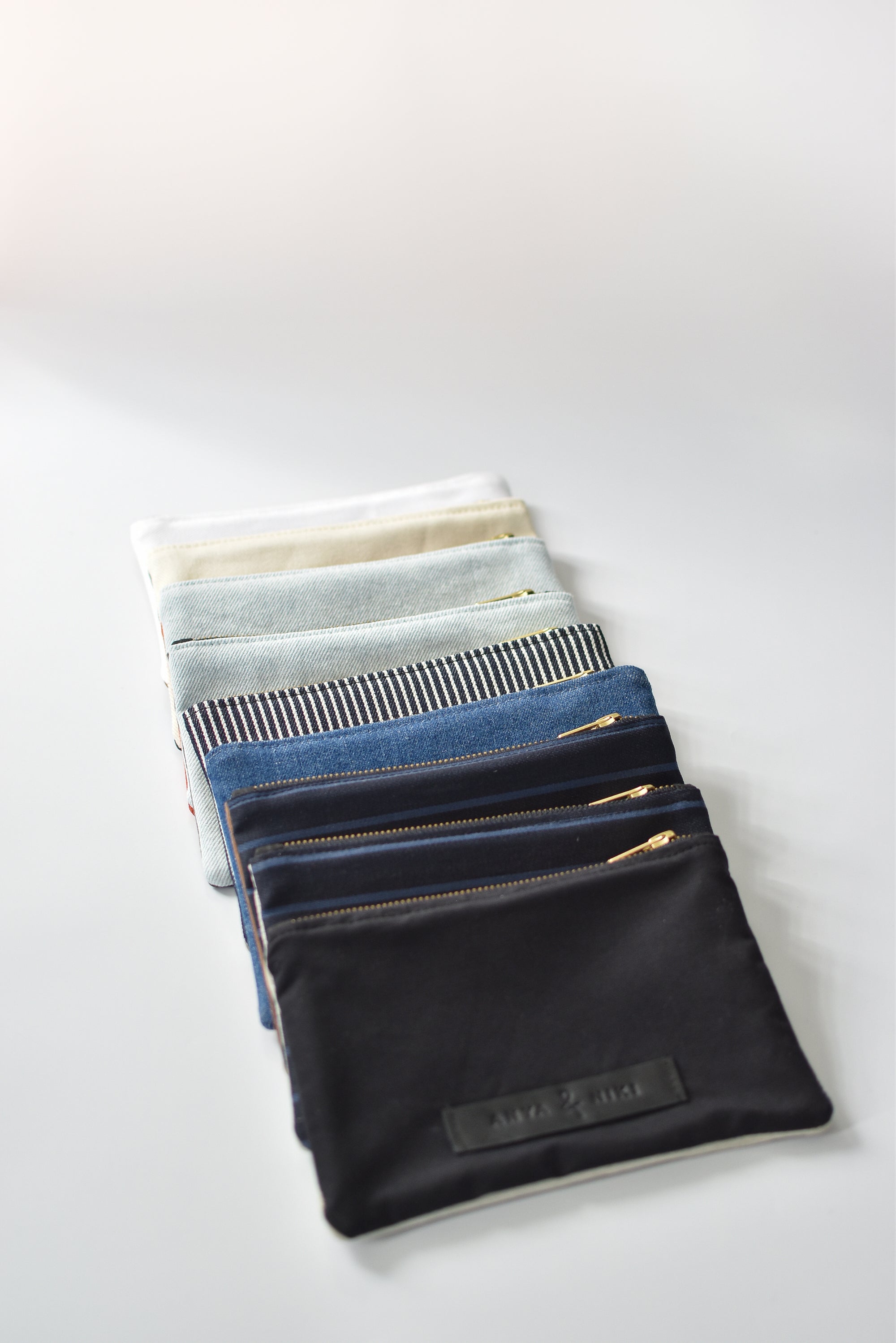 Collection of small limited edition leather and denim pouches from Anya &amp; Niki. 