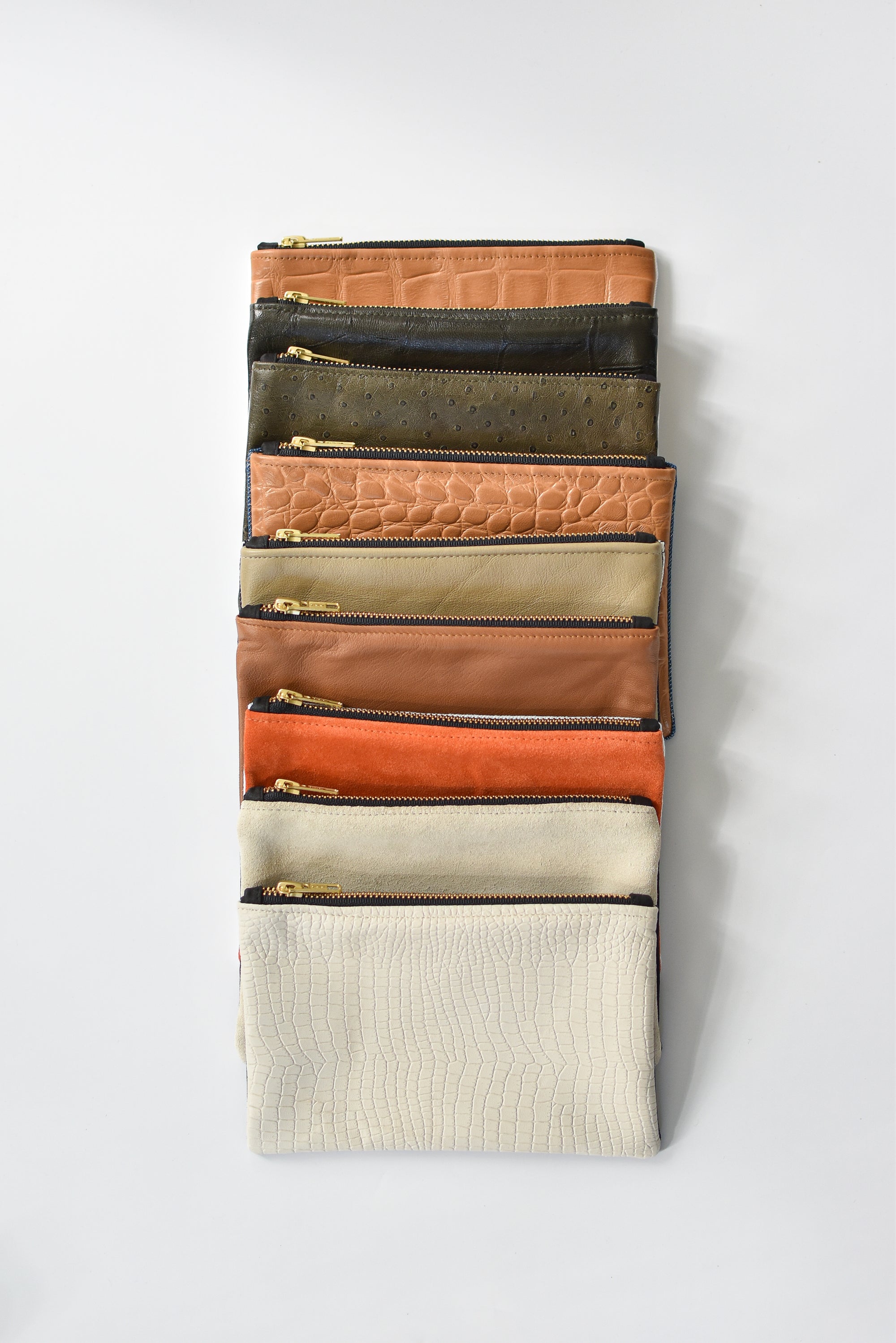 Collection of small limited edition leather and denim pouches from Anya & Niki. 