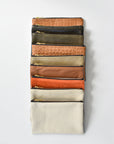 Collection of small limited edition leather and denim pouches from Anya & Niki. 