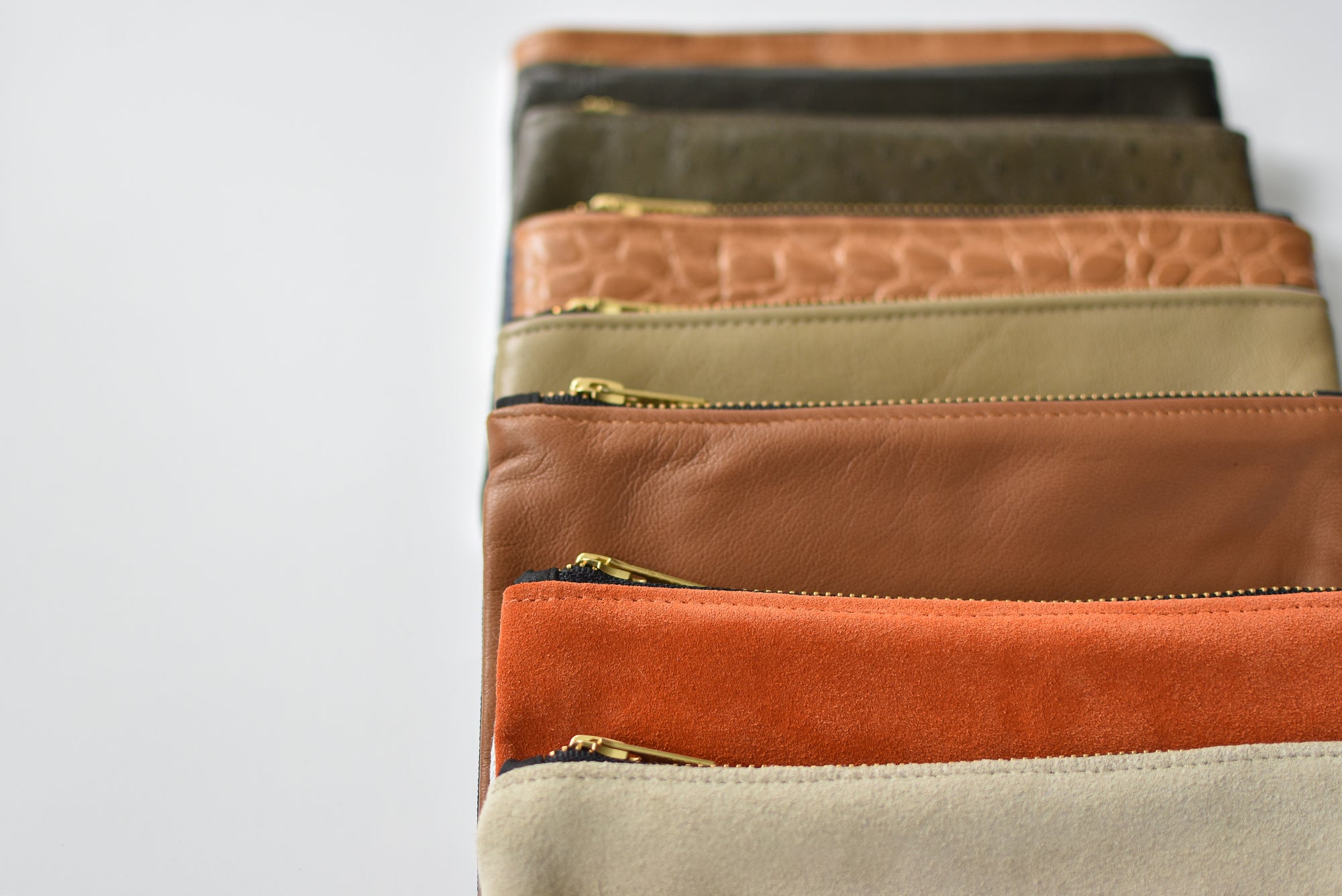 Collection of small limited edition leather and denim pouches from Anya & Niki. 