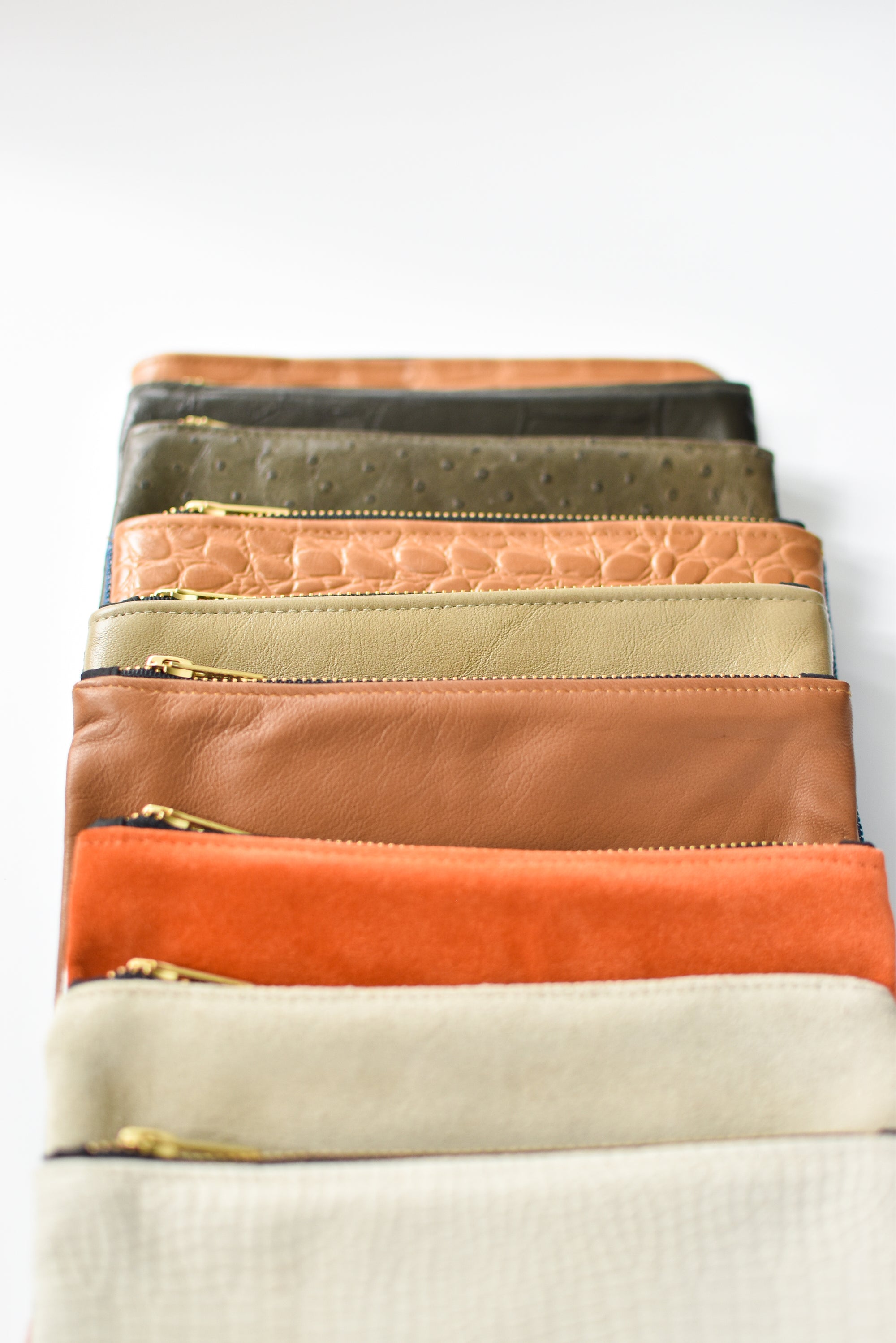 Collection of small limited edition leather and denim pouches from Anya & Niki. 