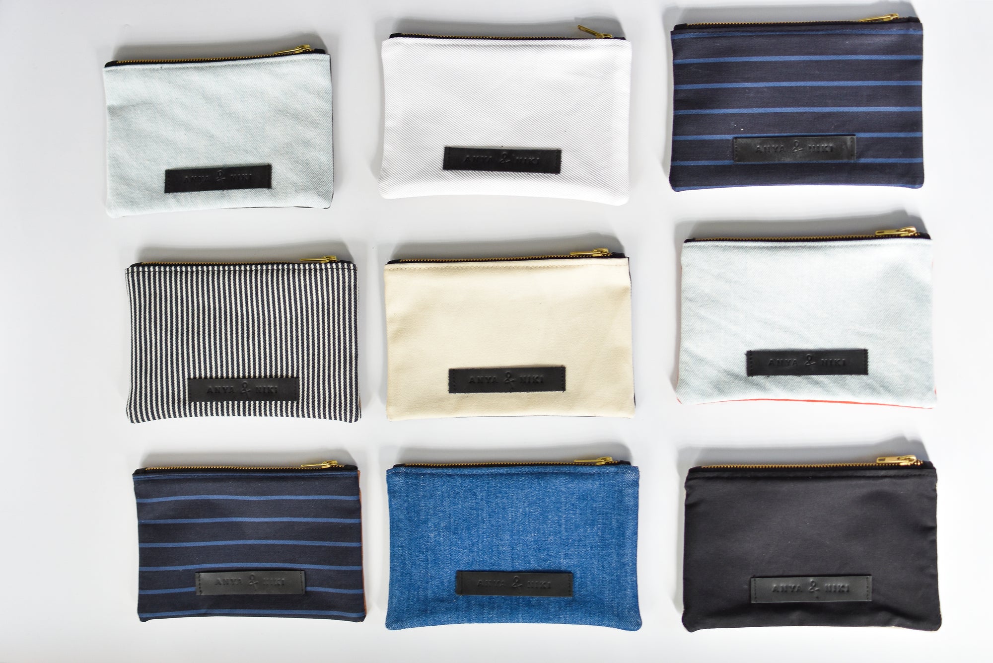 Collection of small limited edition leather and denim pouches from Anya &amp; Niki. 