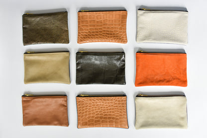 Collection of small limited edition leather and denim pouches from Anya & Niki. 