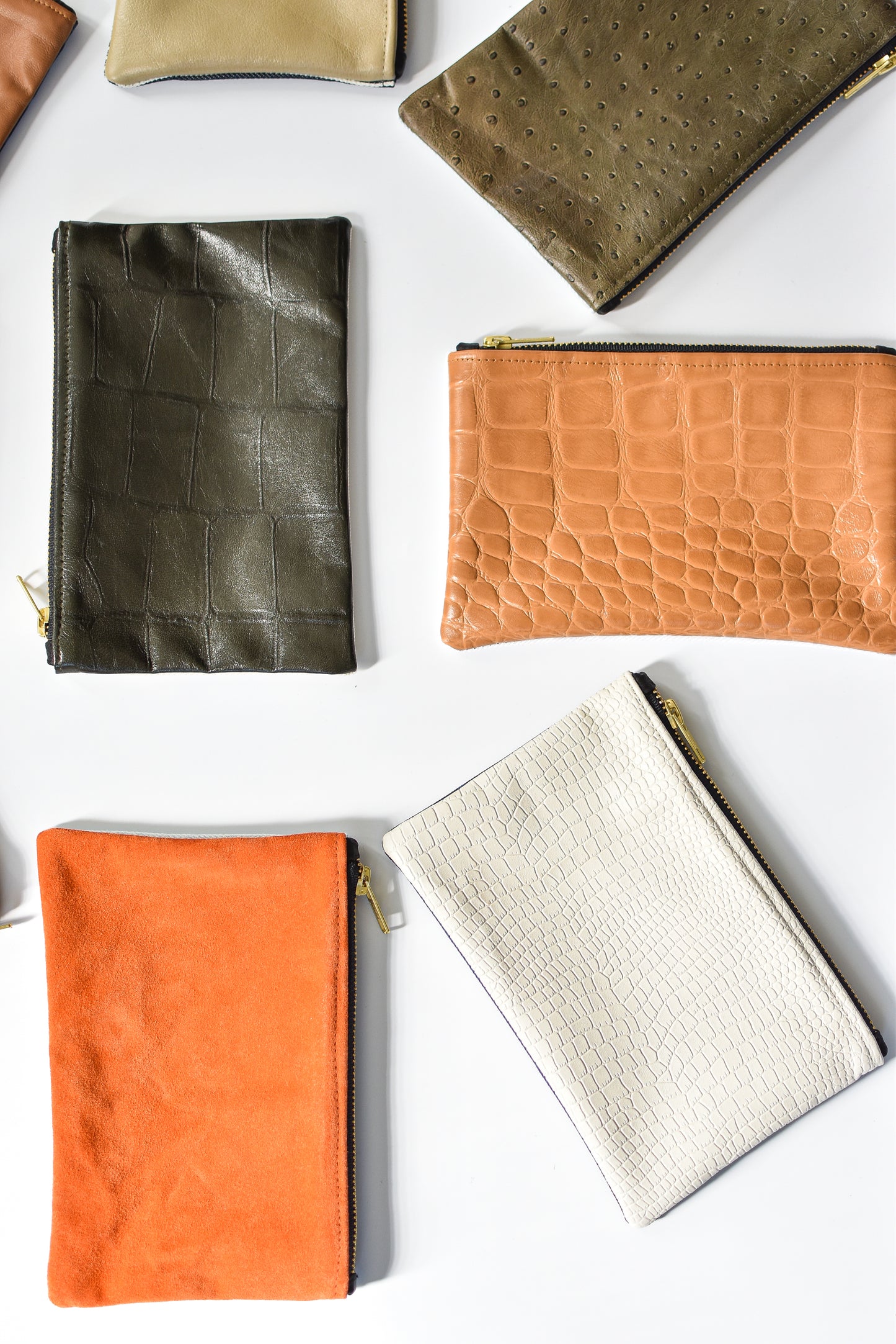 Collection of small limited edition leather and denim pouches from Anya & Niki. 