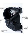 Black nylon flap top backpack with mesh and leather trim details and glossy black lining.