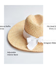 Natural raffia straw panama hat with white grosgrain tie.