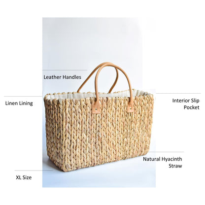 Extra large natural hyacinth straw tote with matching leather handles.