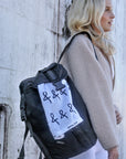 Person wearing the Delray Backpack from Anya & Niki with the sports towel. 