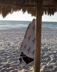 Anya & Niki beach towel haning from cabana post at the beach