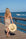 Person holding the Big Hat Natural - a floppy straw hat with black grosgrain ribbon and thin brown leather band.