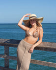 Person wearing the Big Hat Natural - a floppy straw hat with black grosgrain ribbon and thin brown leather band.