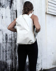 Person wearing off-white faux croc embossed Casselberry backpack