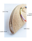 Natural raffia straw half-moon clutch with rainbow colored wrapped circle handle and leather sides.