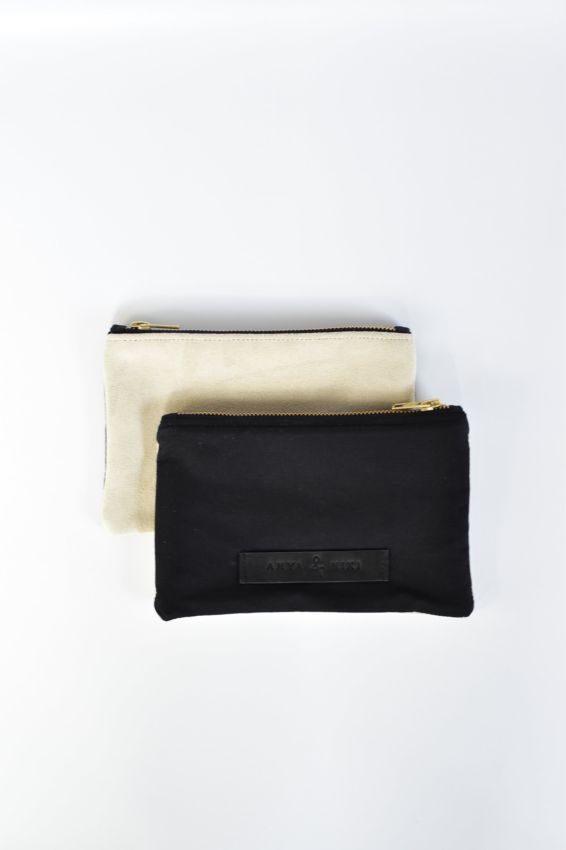 Black cotton canvas and off-white suede small pouch with brass zipper and leather logo label.