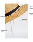 Straw lifeguard hat with tan leather chin strap and black band detail.