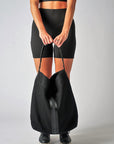 Person holding black sporty mesh tote bag with black leather and webbing details.